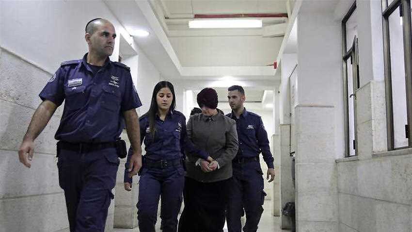 In this Feb. 27, 2018 file photo, Australian Malka Leifer, center, is brought to a courtroom in Jerusalem