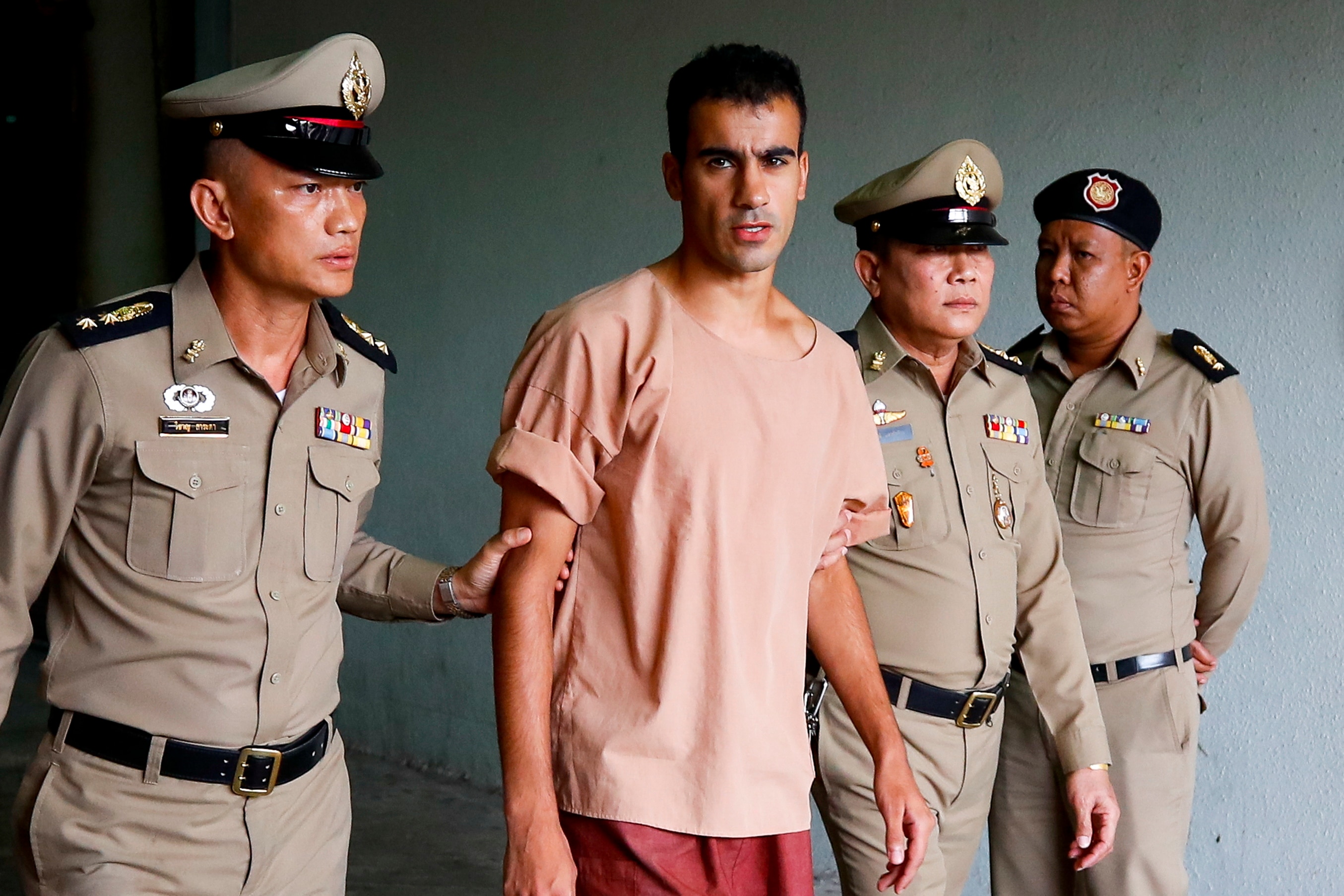 Hakeem Al-Araibi is escorted out of court by Thai prison officers following an extradition hearing at the Criminal Court in Bangkok.