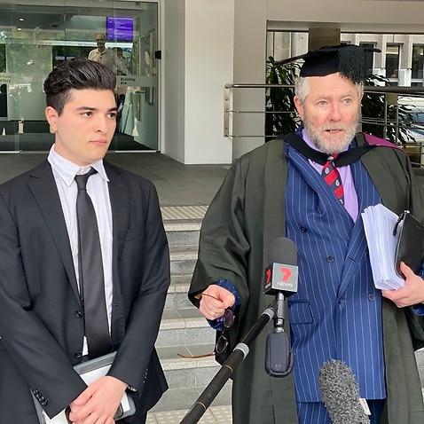 Student Drew Pavlou and barrister Tony Morris outside a UQ disciplinary hearing.