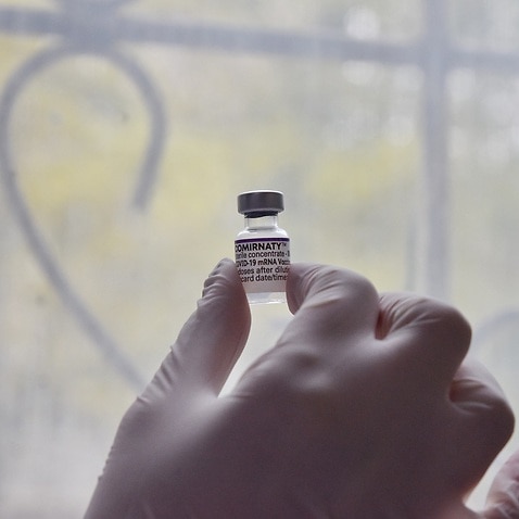 A health worker in Ukraine holds a vial containing Pfizer Covid-19 vaccine