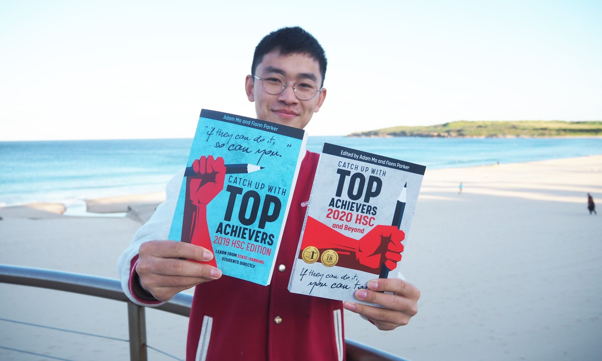 Adam Ma with his books “Catch Up with Top Achievers”.