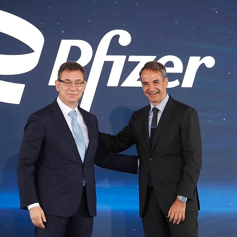 Greek Prime Minister Kyriakos Mitsotakis (R) and Pfizer's CEO Albert Bourla (L)