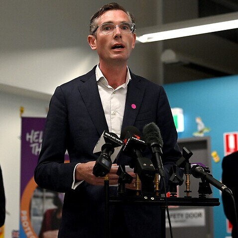 NSW Premier Dominic Perrottet (centre) speaks to the media during a press conference at South Western Sydney Vaccination Centre in Sydney, Wednesday, January 5. 