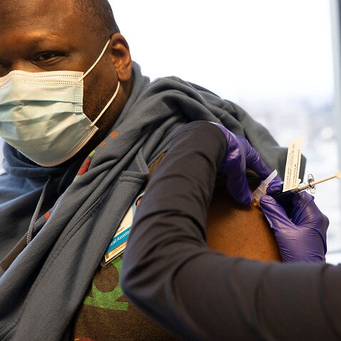 Dr Stephaun Wallace receives his second injection during the Novavax COVID-19 vaccine phase 3 clinical trial in Seattle, Washington, US.