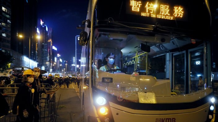 An off-duty bus drives pass a barricades by protesters at Causeway Bay to hold the anti-extradition bill protest in Hong Kong.