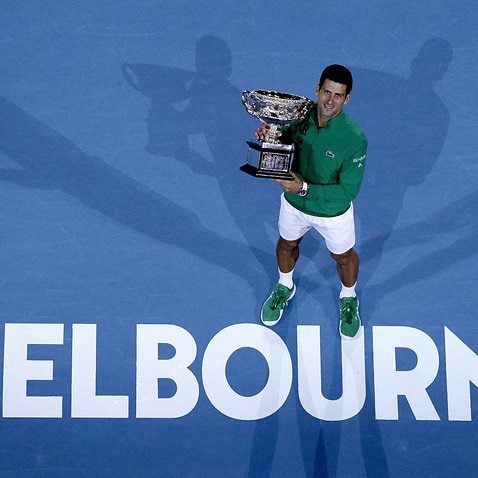 Novak Dkojovic holds his Australian Open trophy 