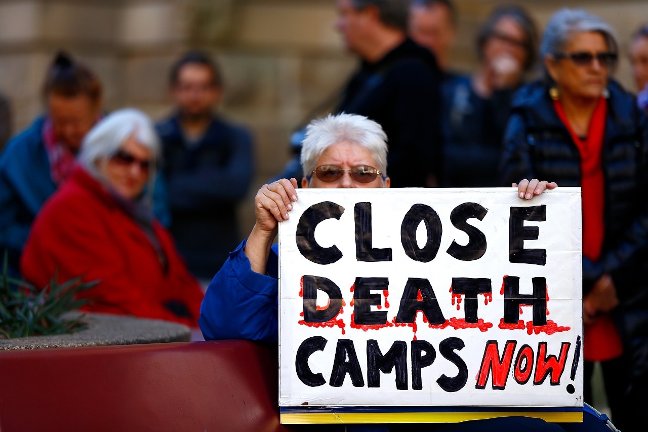 A protester holds a placard during a previous Evacuate Manus and Nauru Protest.