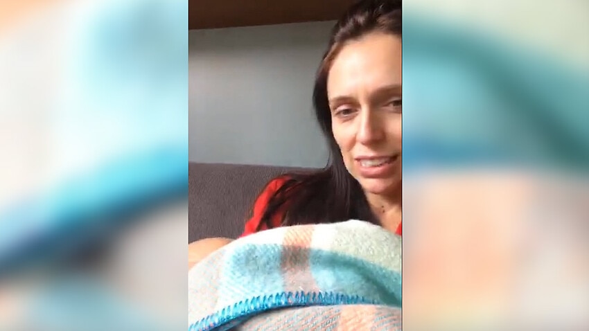 Image for read more article 'NZ PM Jacinda Ardern spruiks policy from her couch - with babe in arms'