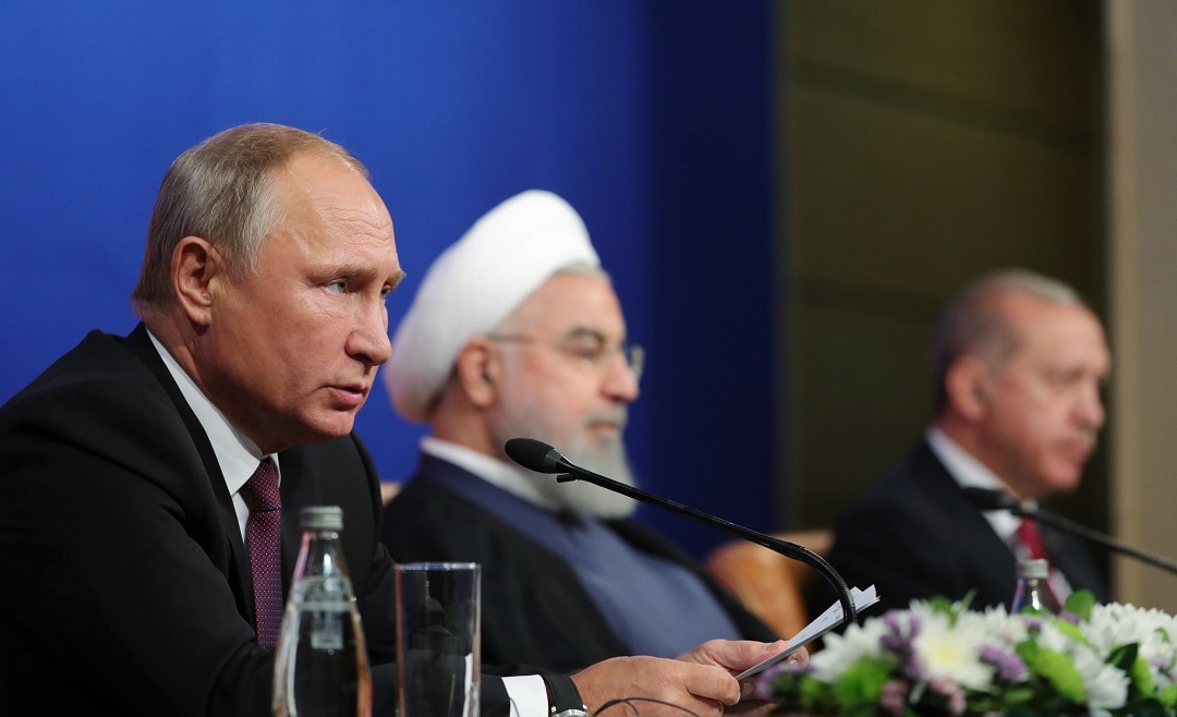 Iranian President Hassan Rouhan (C), Russian President Vladimir Putin (L), and Turkish President Recep Tayyip Erdogan speaking after their meeting in Iran. 