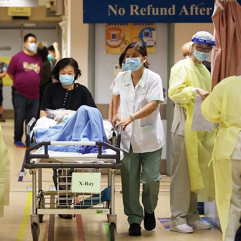Medical staff in protective outfits take precautions with patients at Kwong Wah Hospital in Yau Ma Tei.