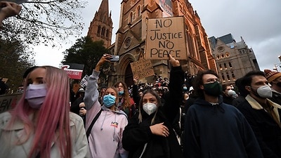 Protesters are seen during a Black Lives Matter rally in Melbourne on 6 June.
