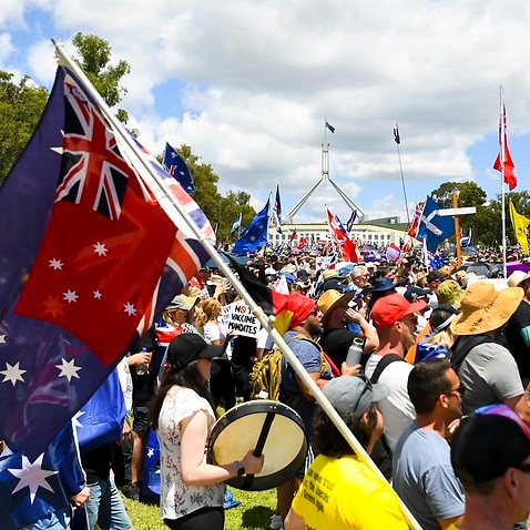Thousands of people take part in a ‘Convoy to Canberra’ protest outside Parliament House in Canberra, Saturday, February 12, 2022.  (AAP Image/Lukas Coch) NO ARCHIVING