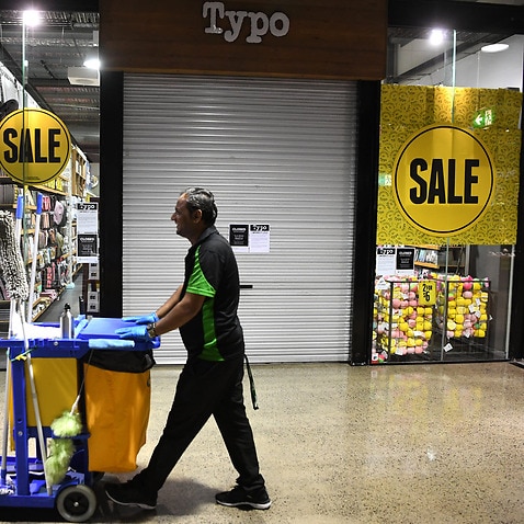 A cleaner walks through a Brisbane shopping centre 