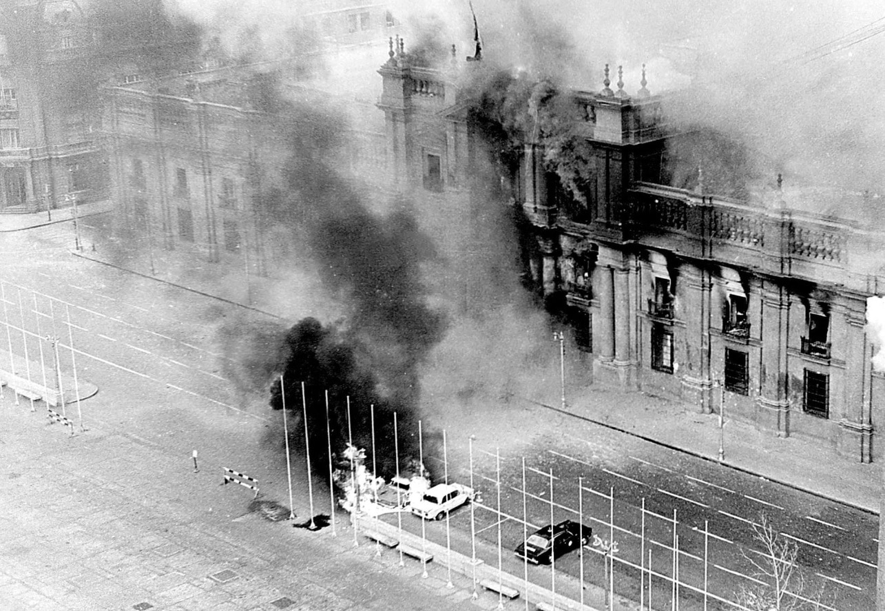 Smoke pours from the Chilean presidential palace, La Moneda, in this Sept. 11, 1973 file photo after being hit by rockets fired by the air force Hawker Hunter (AAP) Smoke pours from the Chilean presidential palace, La Moneda, in this Sept. 11, 1973 file photo after being hit by rockets fired by the air force Hawker Hunter jet fighters