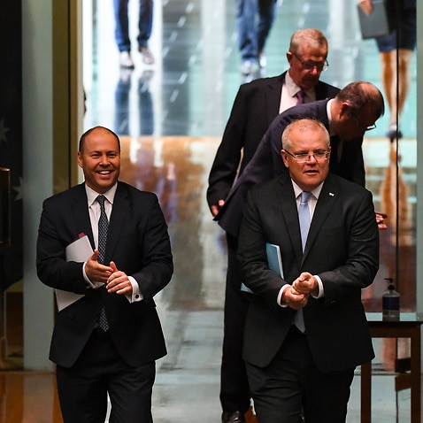 Prime Minister Scott Morrison (R) and Treasurer Josh Frydenberg (L) attend a parliamentary sitting.