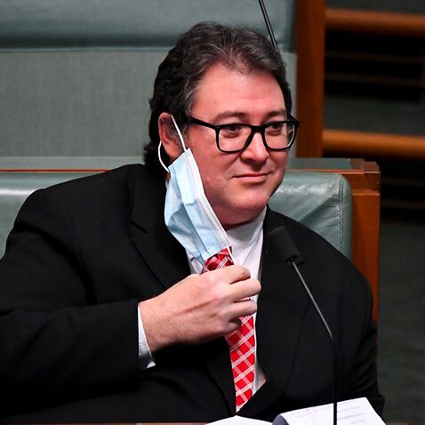 The Member for Dawson George Christensen removes a face mask during House of Representatives Question Time at Parliament House in Canberra