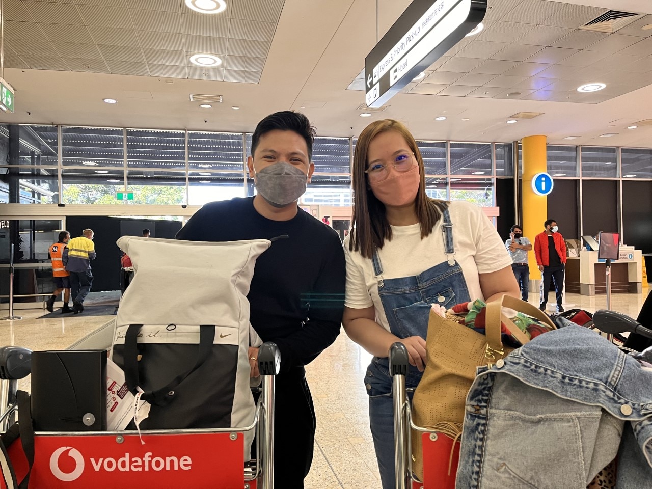 Zady Flores (left) and his partner at Sydney airport on Wednesday morning