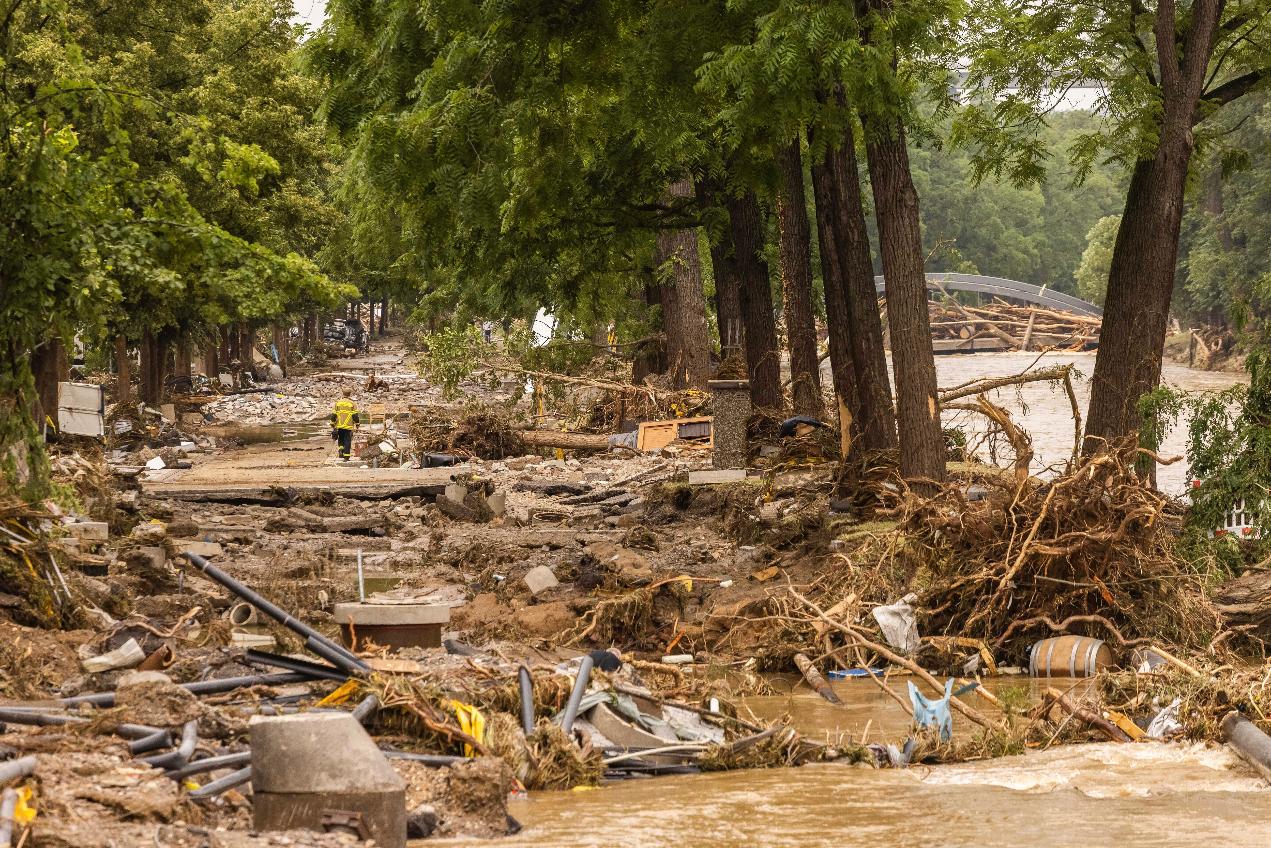 A firefighter walks through a debris field caused by flooding in Rhineland-Palatinate, Bad Neuenahr, on 16 July.