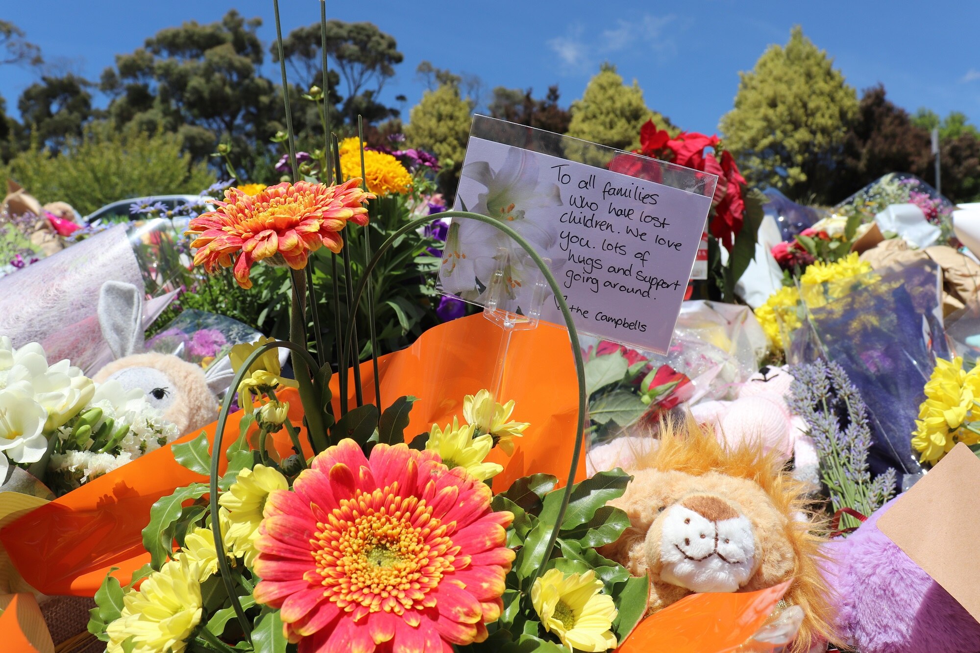 Flowers and tributes continue to grow outside Hillcrest Primary School as several thousand pay their respects.