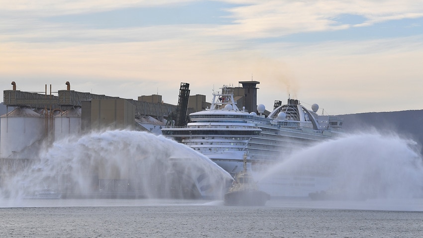 A tugboat sprays water as the Ruby Princess cruise ship prepares to depart Port Kembla in Wollongong, New South Wales