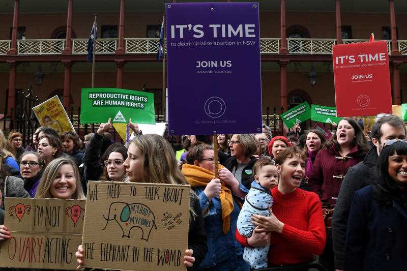 Pro-choice advocates and supporters of the Reproductive Health Care Reform Bill hold a rally outside the New South Wales Parliament.