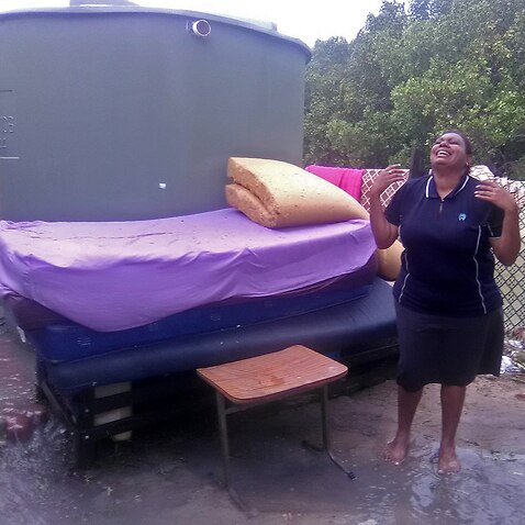 A distraught Torres Strait islander after her home is inundated with sea water from king tides.