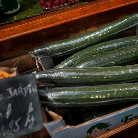Cucumbers wrapped in plastic packaging are on display at a Paris supermarket on 31 December, 2021.