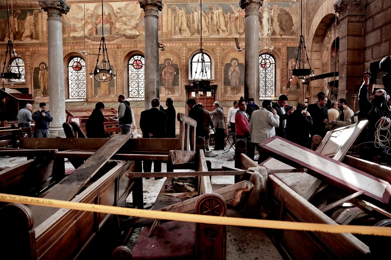 Security forces examine the scene inside the St. Mark Cathedral in central Cairo, following a bombing, November 2016.