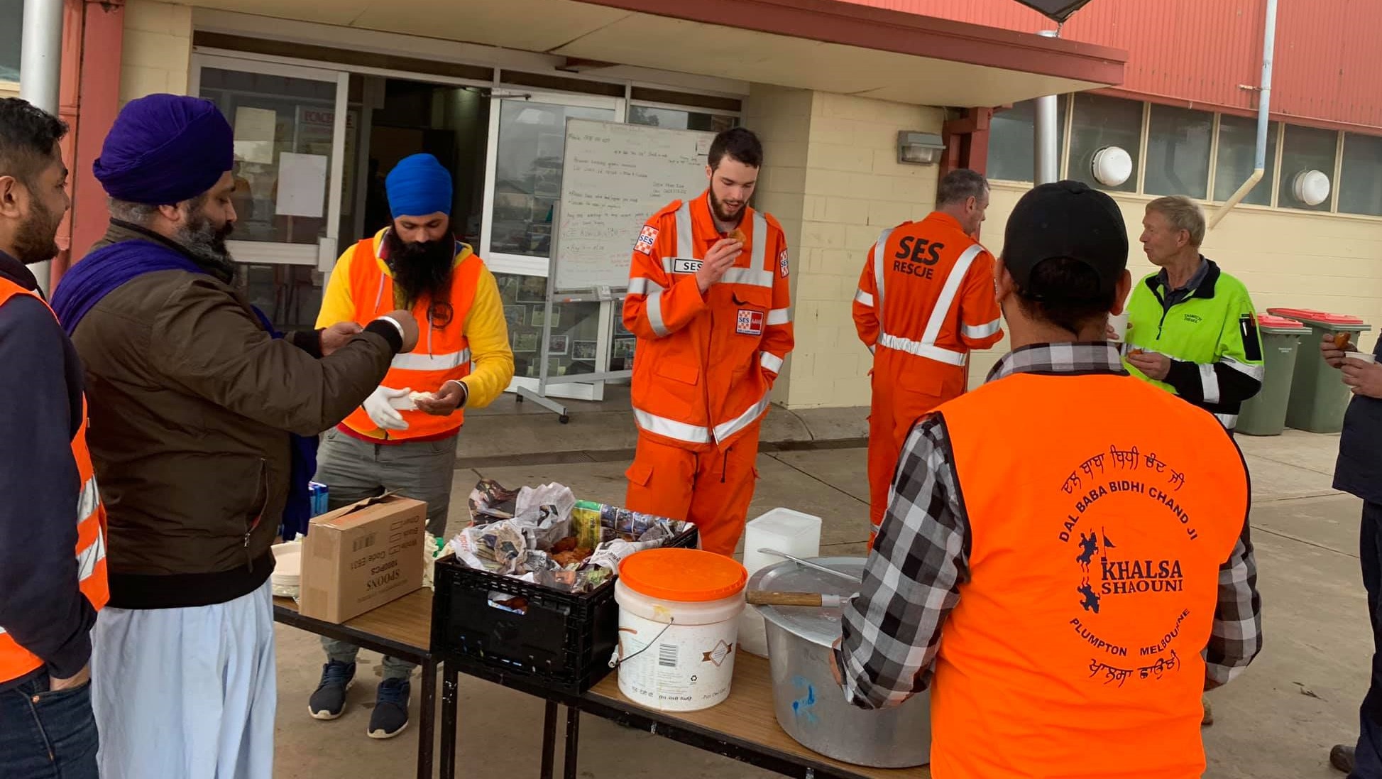 Volunteers of Khalsa Shaoni Plumpton serving food to SES workers. 