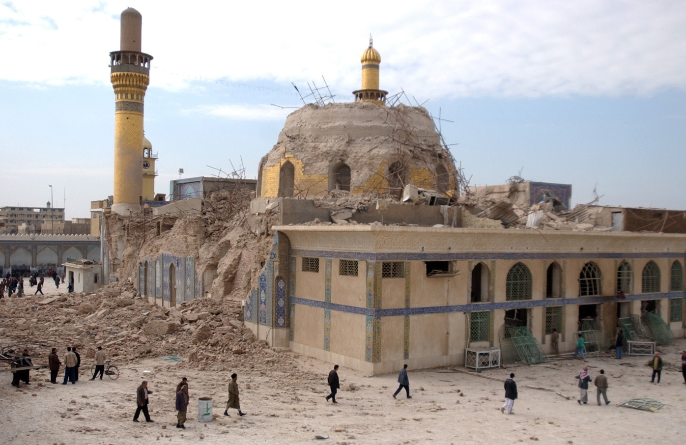 Iraqis walk past the damaged Askariya shrine following an explosion in Samarra, 95 kilometers (60 miles) north of Baghdad, in this Wednesday, Feb. 22, 2006.