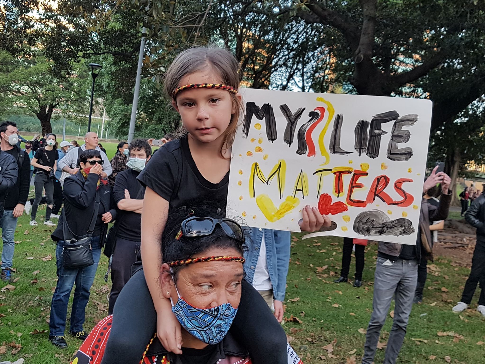 A young girl holds up a sign during the Sydney protest
