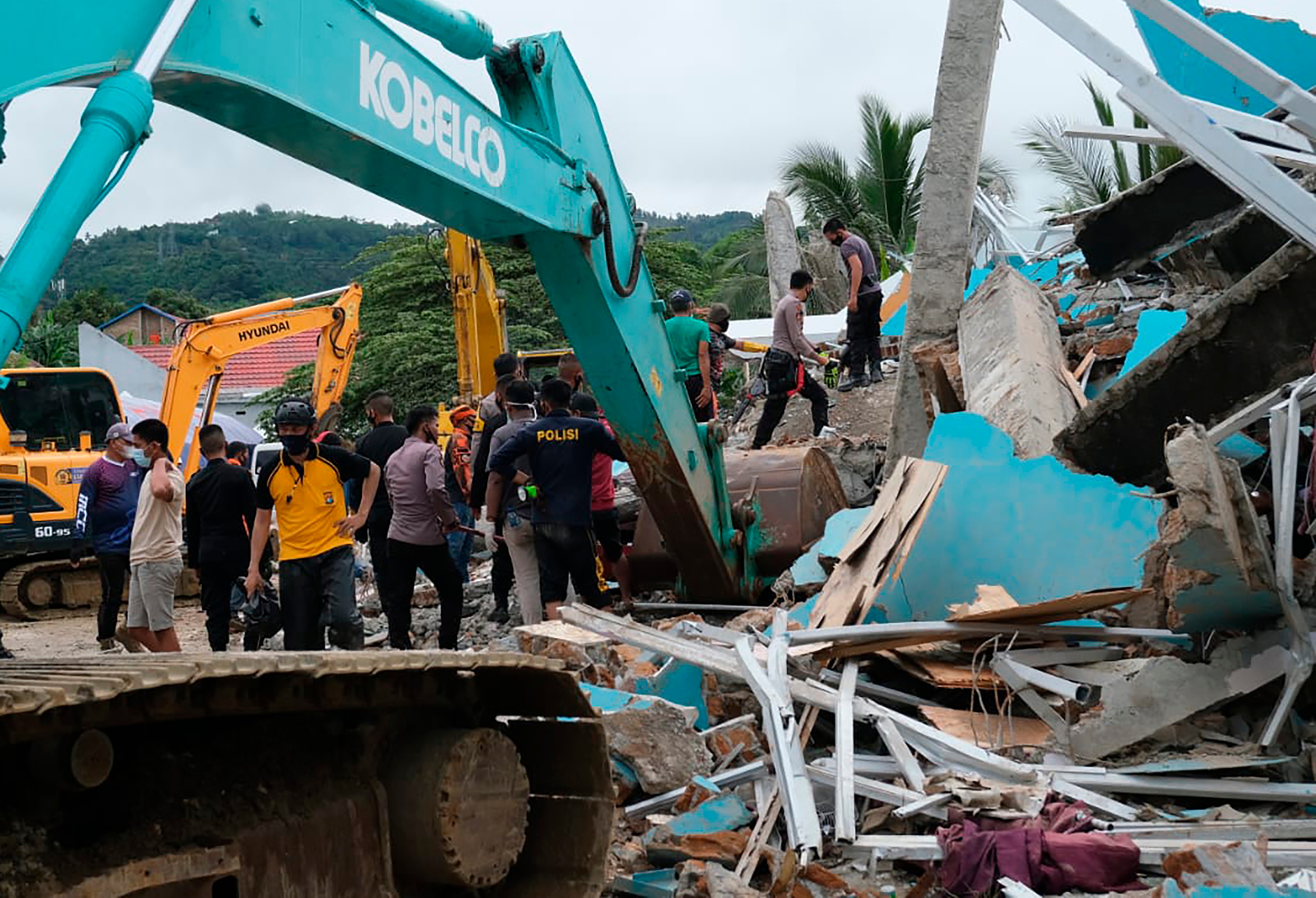 Die Bewohner inspizieren ein erdbebengeschädigtes Gebäude in Mamuju, West-Sulawesi, Indonesien, Freitag, 15. Januar 2021. 