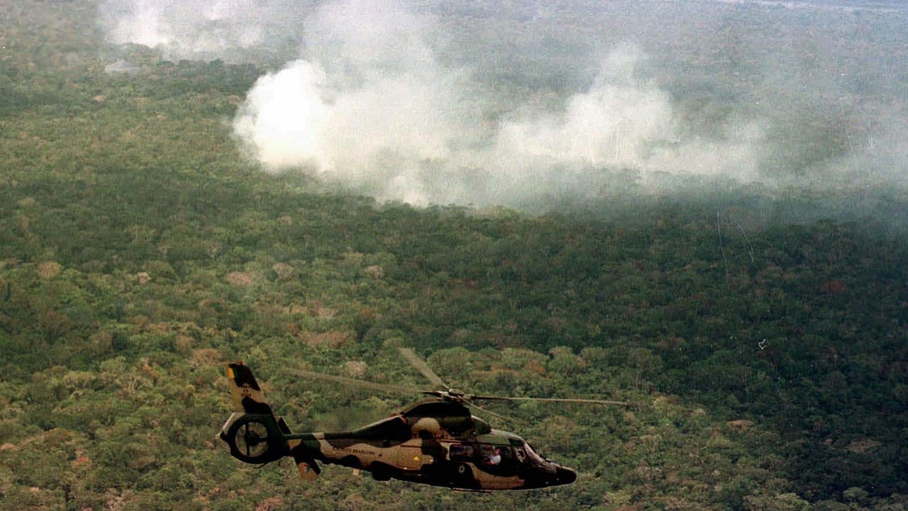 Members of the enviormental commision of the Brazilian Congress, fly in a army helicopter over an area of the Amazon forest affected by fires.