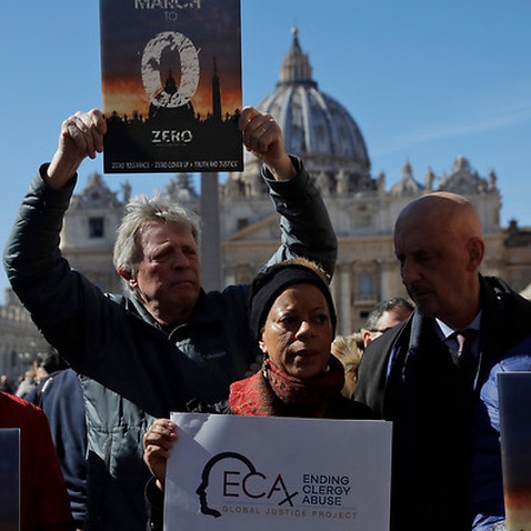 Sex abuse survivors and protestors show banners at the Vatican 