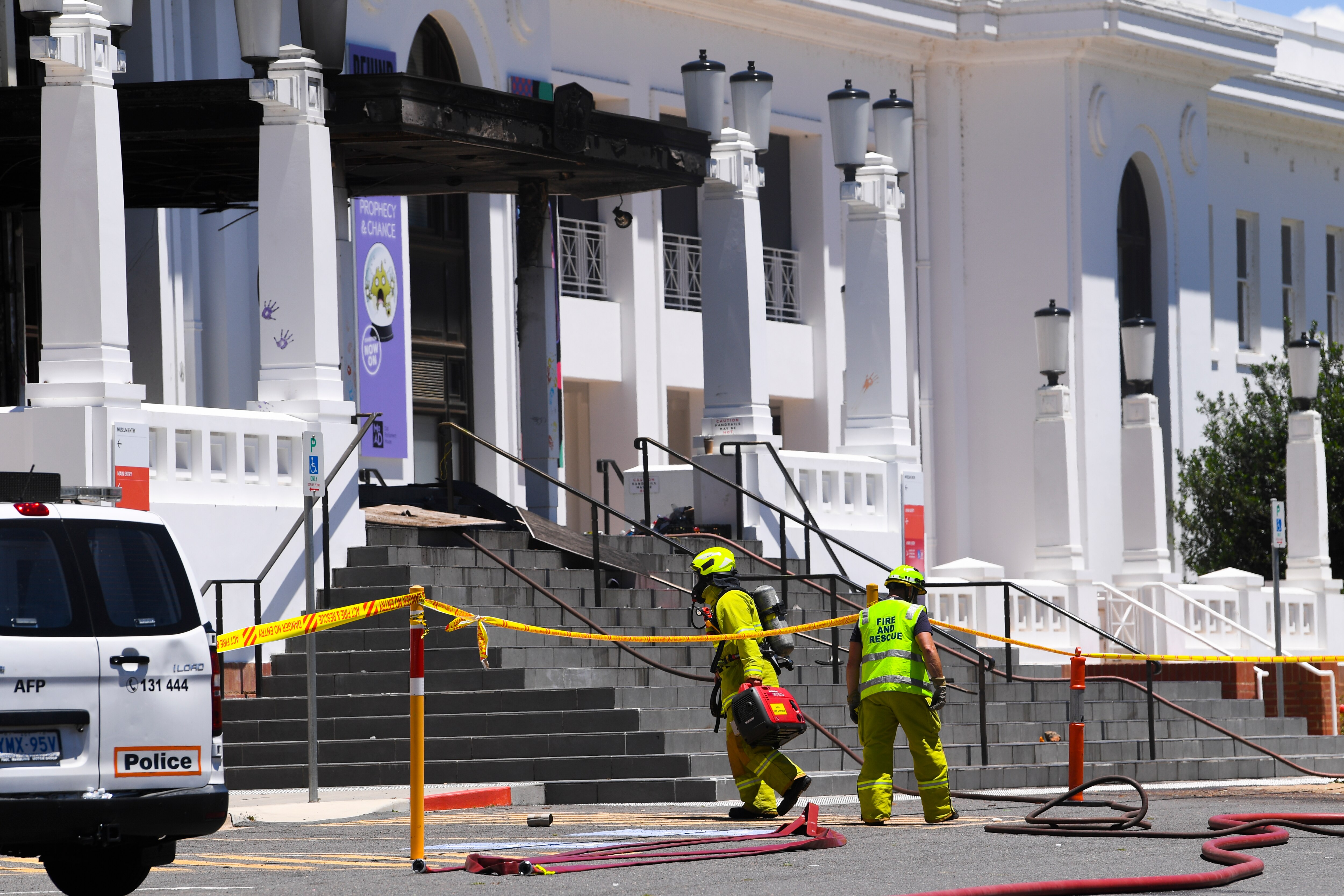 Firefighters are seen entering the fire-damaged entrance to the Old Parliament House in Canberra, Thursday, December 30, 2021.