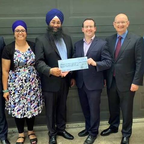 Julian Hill MP, Shayne Neumann MP, with Jatinder Kaur (manager Sahara House) and members from the Brisbane Sikh temple receiving a donation of $8887 from the CEO of Key Assets in December 2018