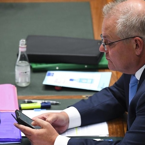 PM Scott Morrison looking at mobile phone at Question Time