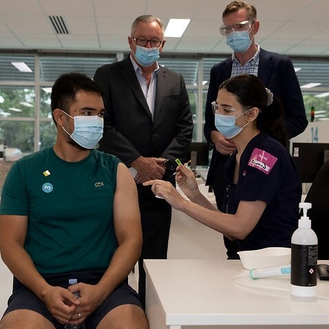 NSW Premier Dominic Perrottet and Brad Hazzard, Minister for Health and Medical Research NSW observe booster shots being administered during a visit to the Sydney Olympic Vaccination Hub.