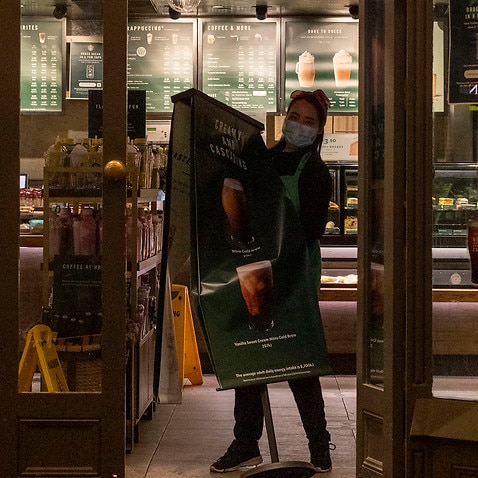 A Starbucks coffee franchise workers packs up to close the store as lockdown of Melbourne forces people to stay at home.