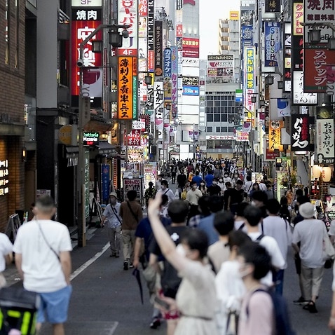 A street is crowded with people in Tokyo's Shinjuku district on 22 July 2021.