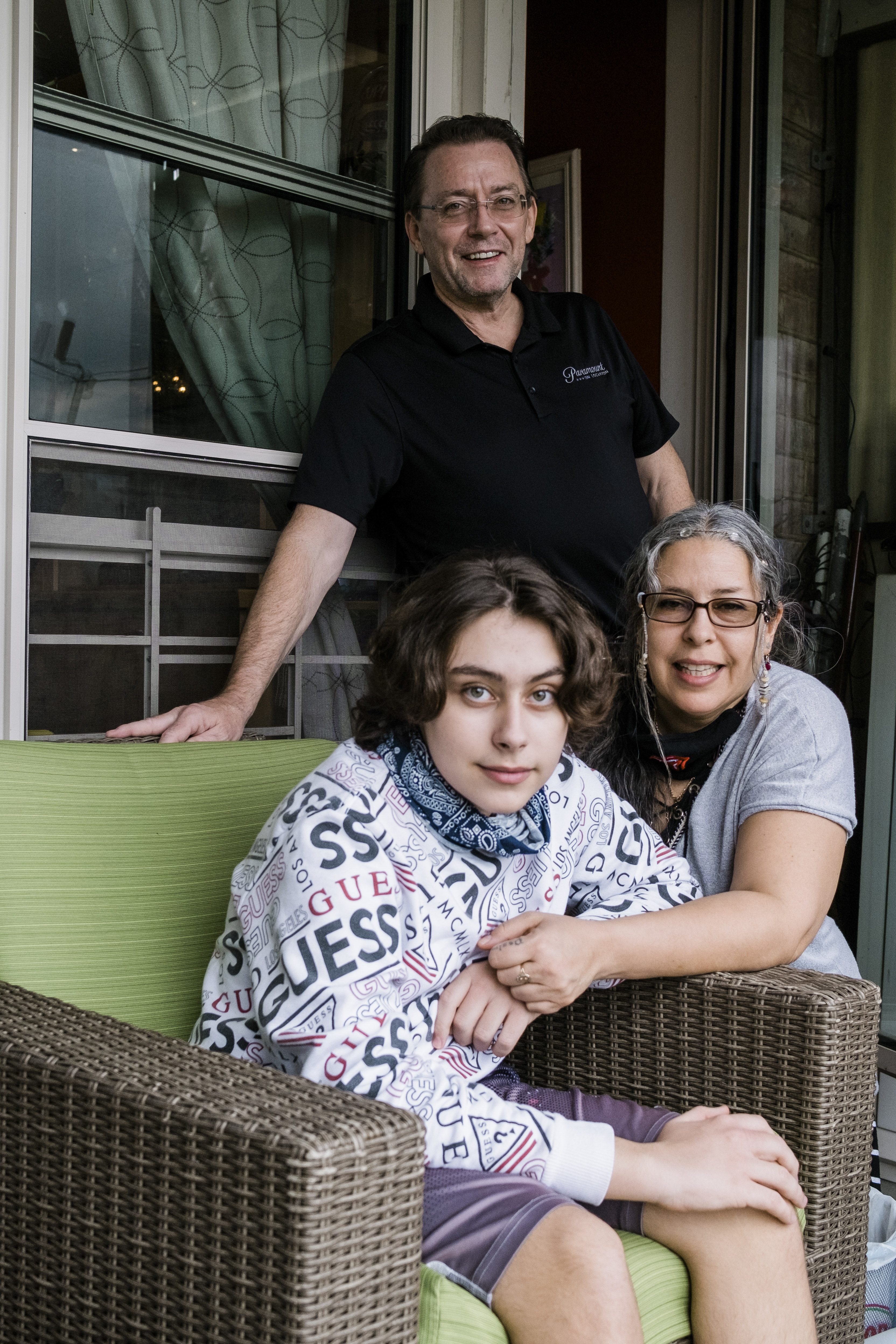 Jack McMorrow, 14, and his parents on the balcony of their home in Queens, 11 May, 2020. 