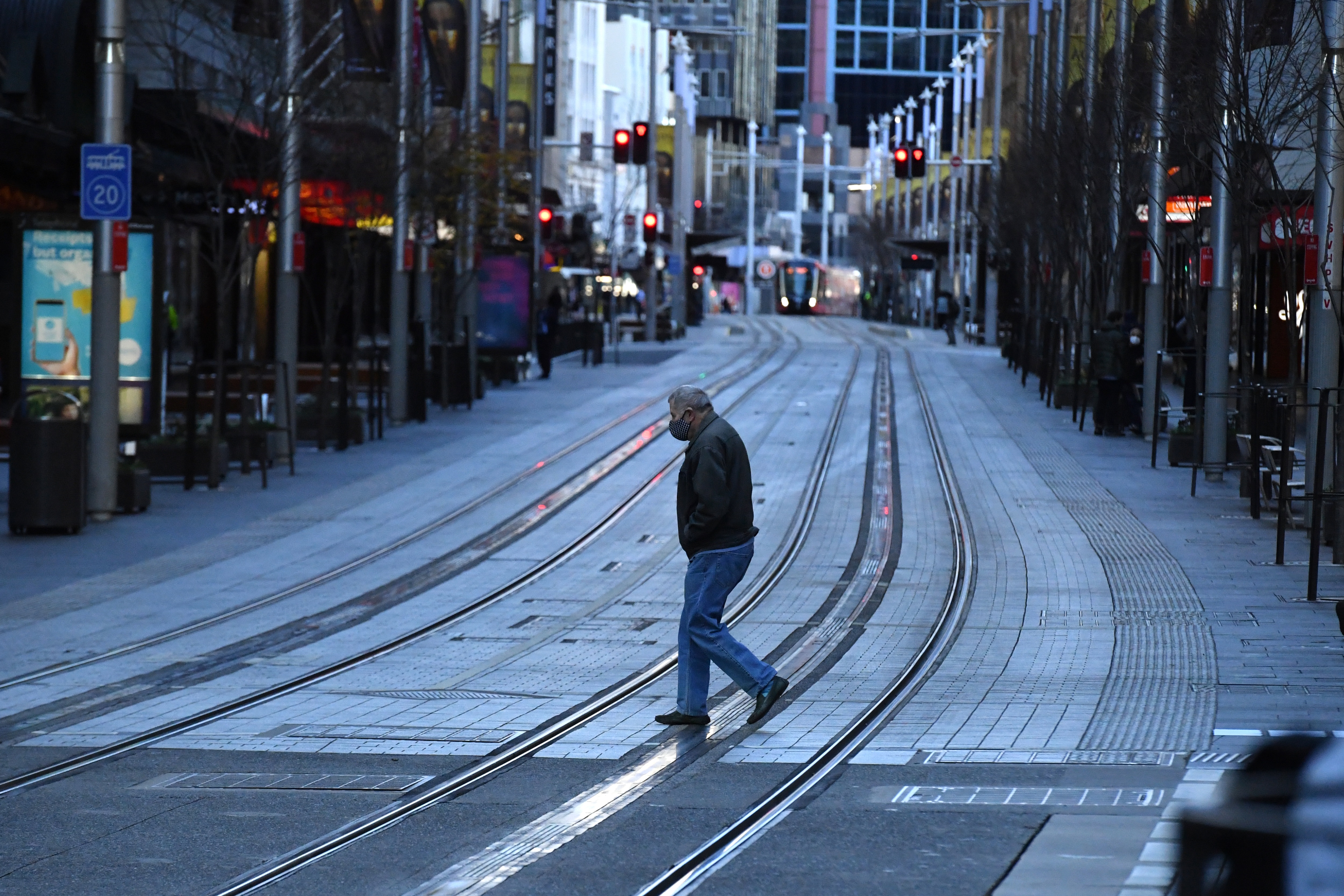 A pedestrian walks along George St in the central business district in Sydney, 20 July 2021. 