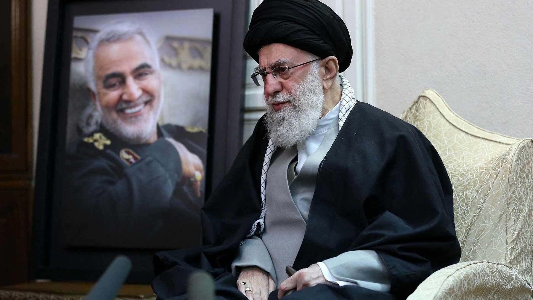 Iranian Revolution supreme leader Ali Khamenei pictured beside a portrait of Qasem Soleimani.