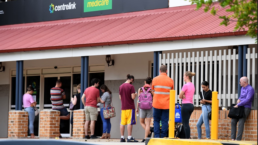 People in a long queue outside a Centrelink office in Brisbane.