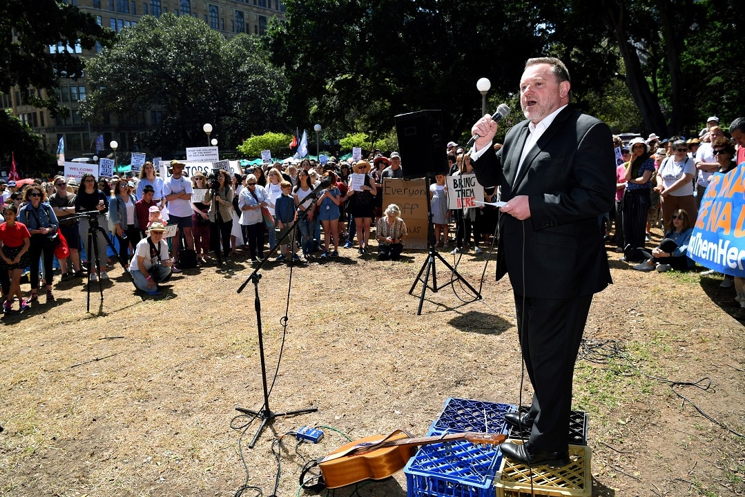 Father Rod Bower addresses a rally to call for an end to the refugee crisis on Nauru and Manus Island.