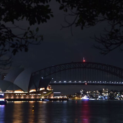 Sydney Harbour Bridge and the Opera House are plunged into darkness for the Earth Hour environmental campaign