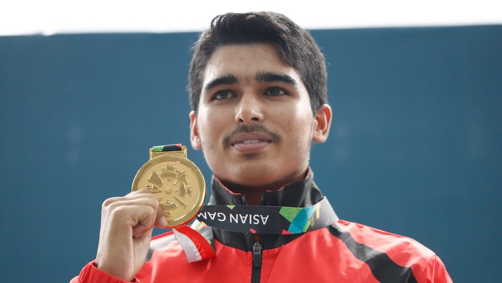 Gold medalist India's Saurabh Chaudhary, poses for photographers after the 10m air pistol men's final shooting event during the 18th Asian Games in Palembang, Indonesia, Tuesday, Aug. 21, 2018. (AP Photo/Vincent Thian)
