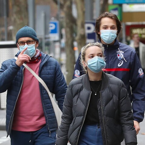 People are seen wearing masks in Bourke street in Melbourne, Sunday, 19 July, 2020.