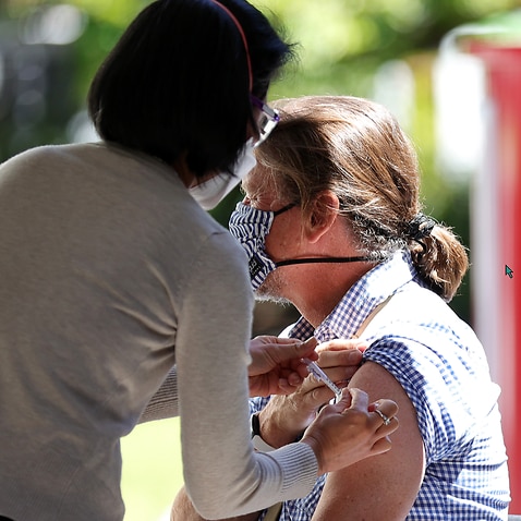 A woman is seen receiving a vaccination at a Cohealth pop-up vaccination clinic at the State Library Victoria, in Melbourne. 