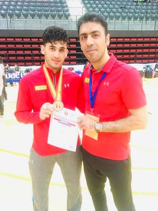 Abdullah Sediqi with his coach Ali Reza Naser Azadani after winning silver at the Spanish Open 2019.